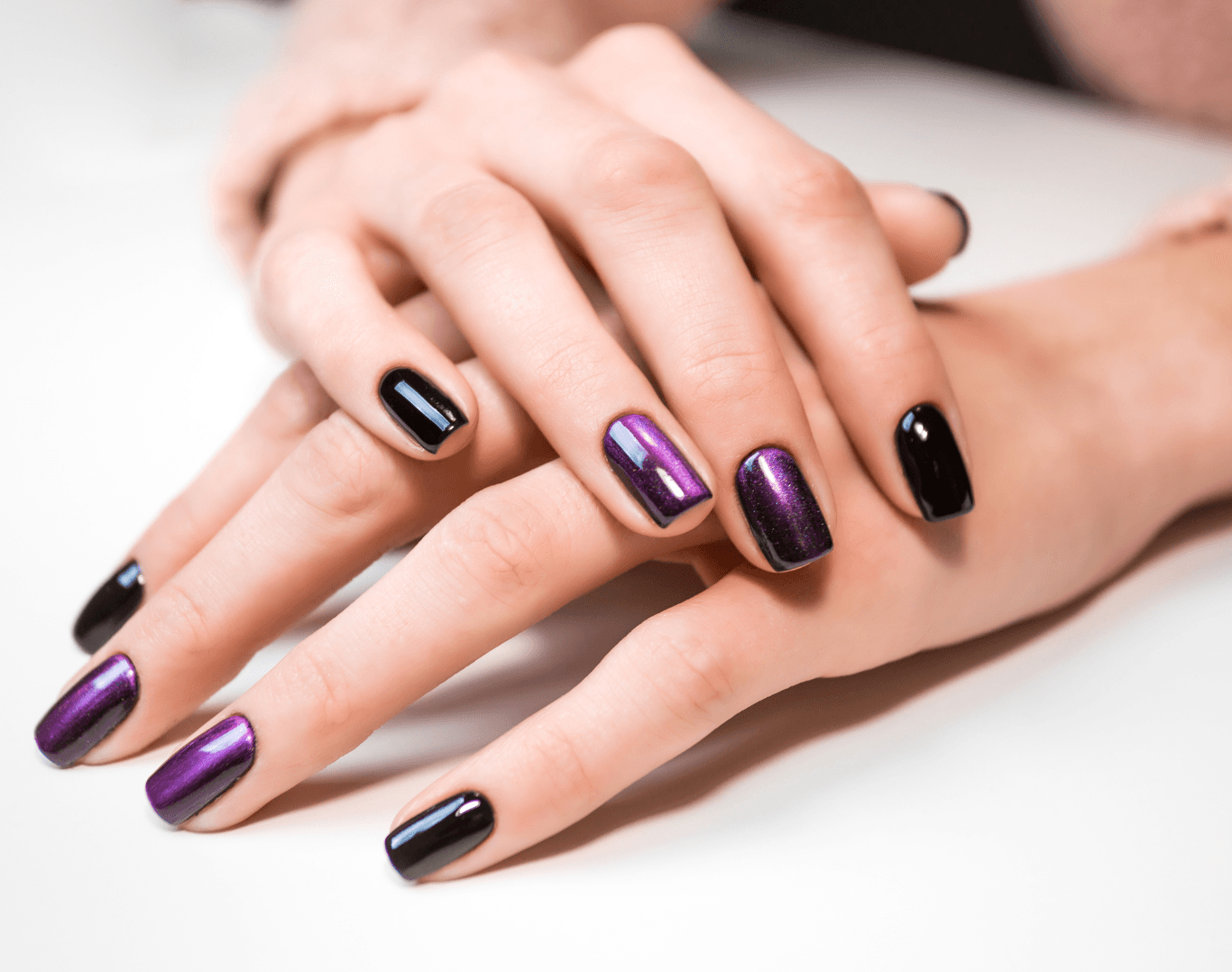 Glossy shellac manicure in deep purple tones at The Beauty Spot in Wadebridge